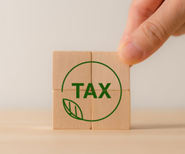 Environmental tax obligation, breaks concept. Wooden blocks with green taxes icons