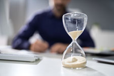 Man Looking at Hourglass