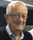 Old man with glasses smiling